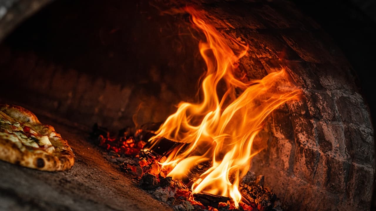 Close-up of wood fire inside the pizza oven.